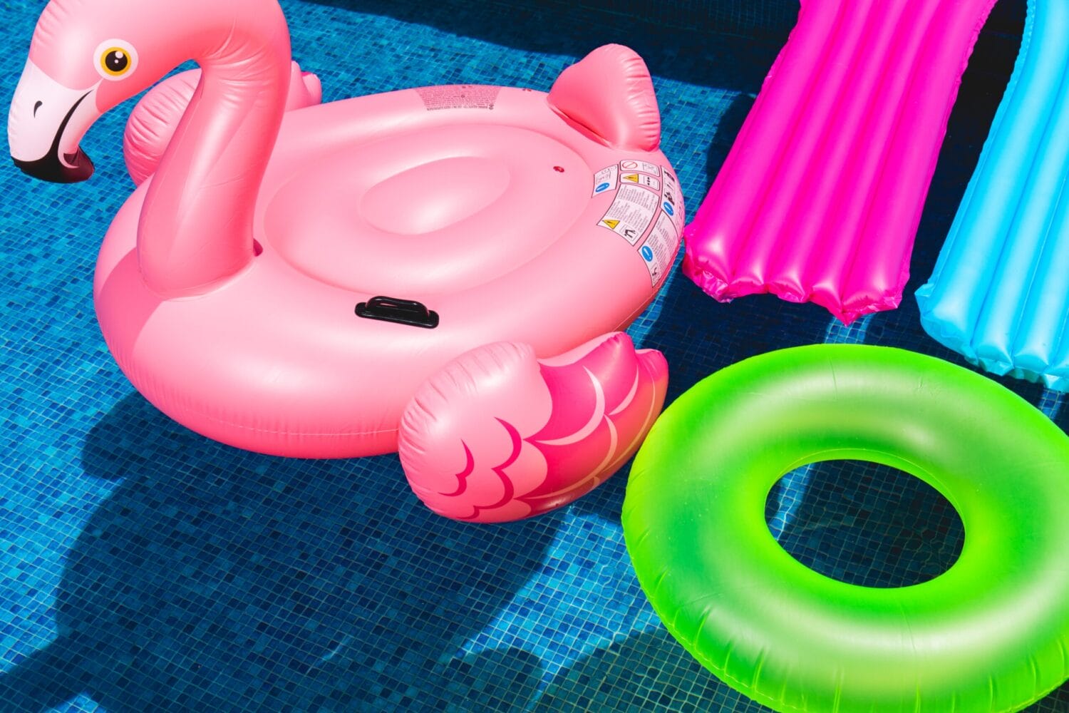 brightly colored pool floats in a pool