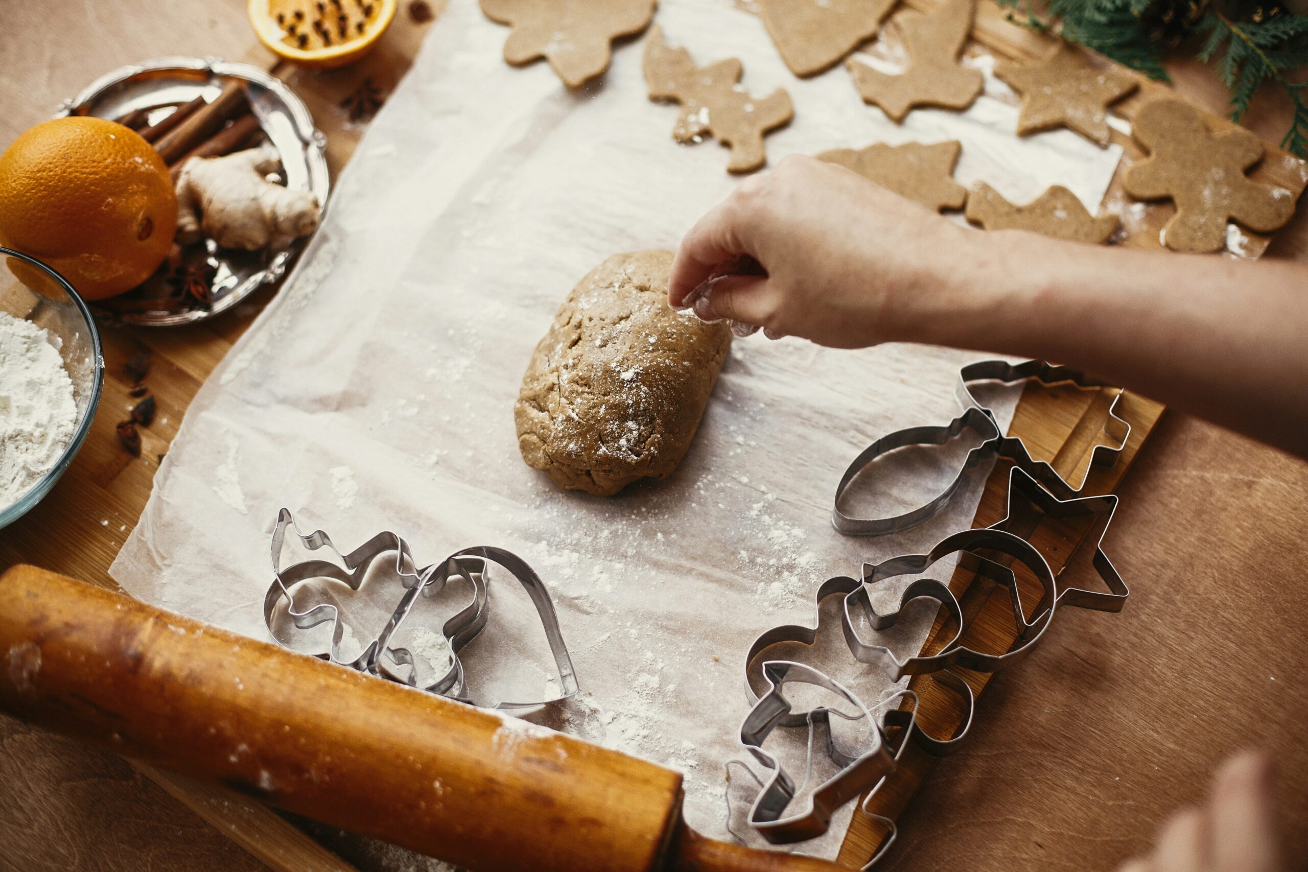 a person makes gingerbread cookies at a winter fundraising workshop